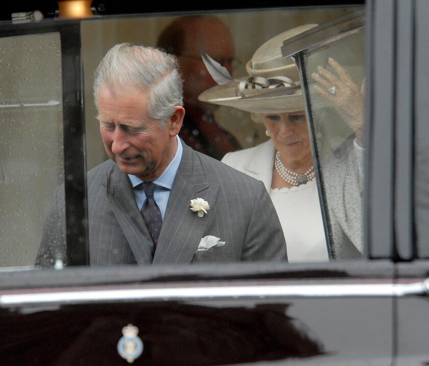 113204s06a 
 113204 - Duke of Edinburgh's 90th Birthday Service at St. Georges Chapel, Windsor - Mike Swift 12/6/2011
Ladies First .. NOT - Charles jumps out of the rain and into the car first leaving the Duchess of Cornwall to follow