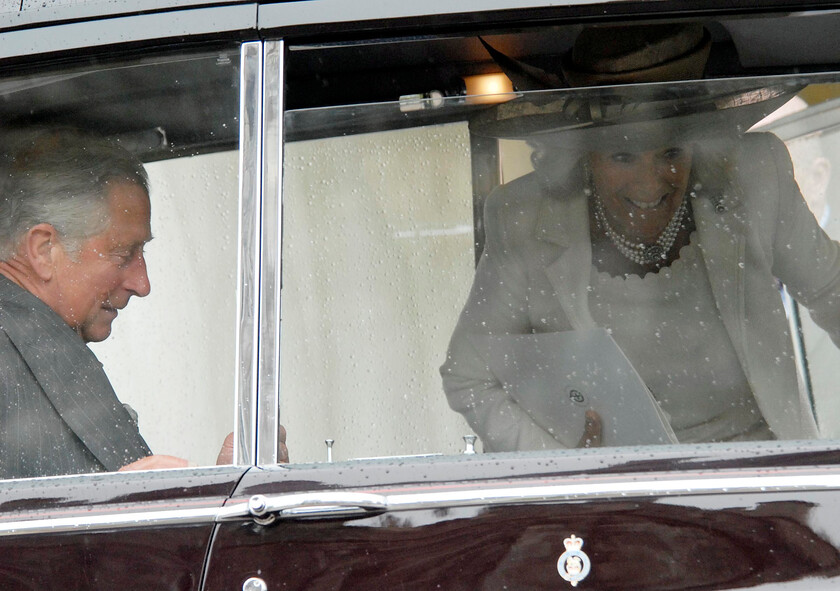 113204s07a 
 113204 - Duke of Edinburgh's 90th Birthday Service at St. Georges Chapel, Windsor - Mike Swift 12/6/2011
Ladies First .. NOT - Charles jumps out of the rain and into the car first leaving the Duchess of Cornwall to follow